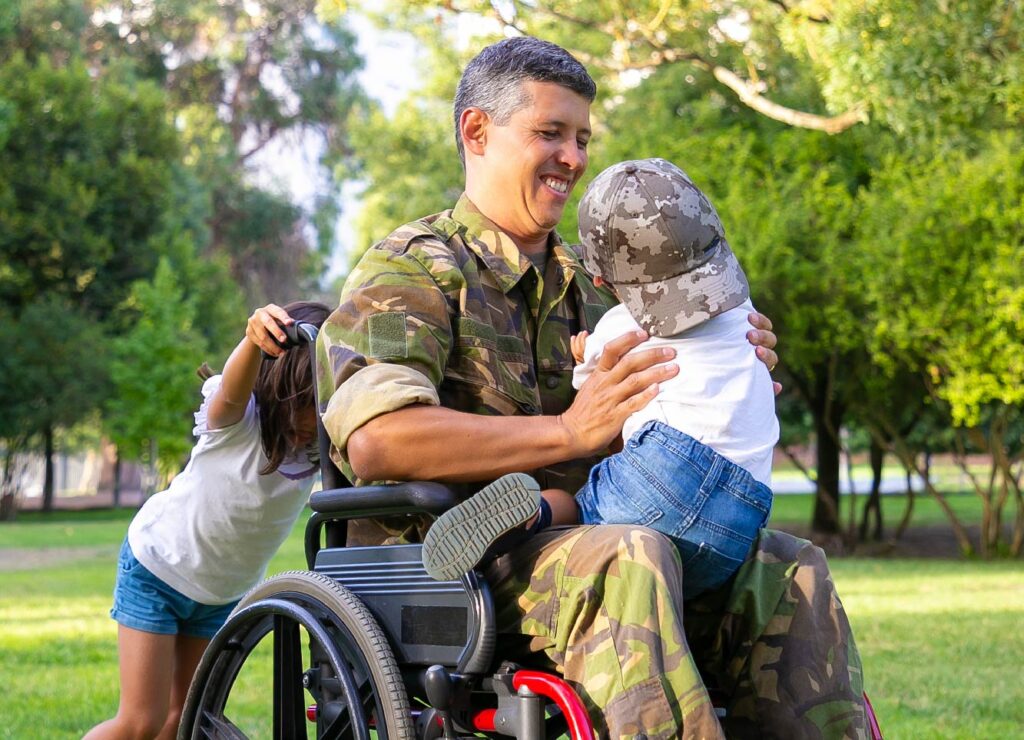Veteran father in a wheel chair playing with his children